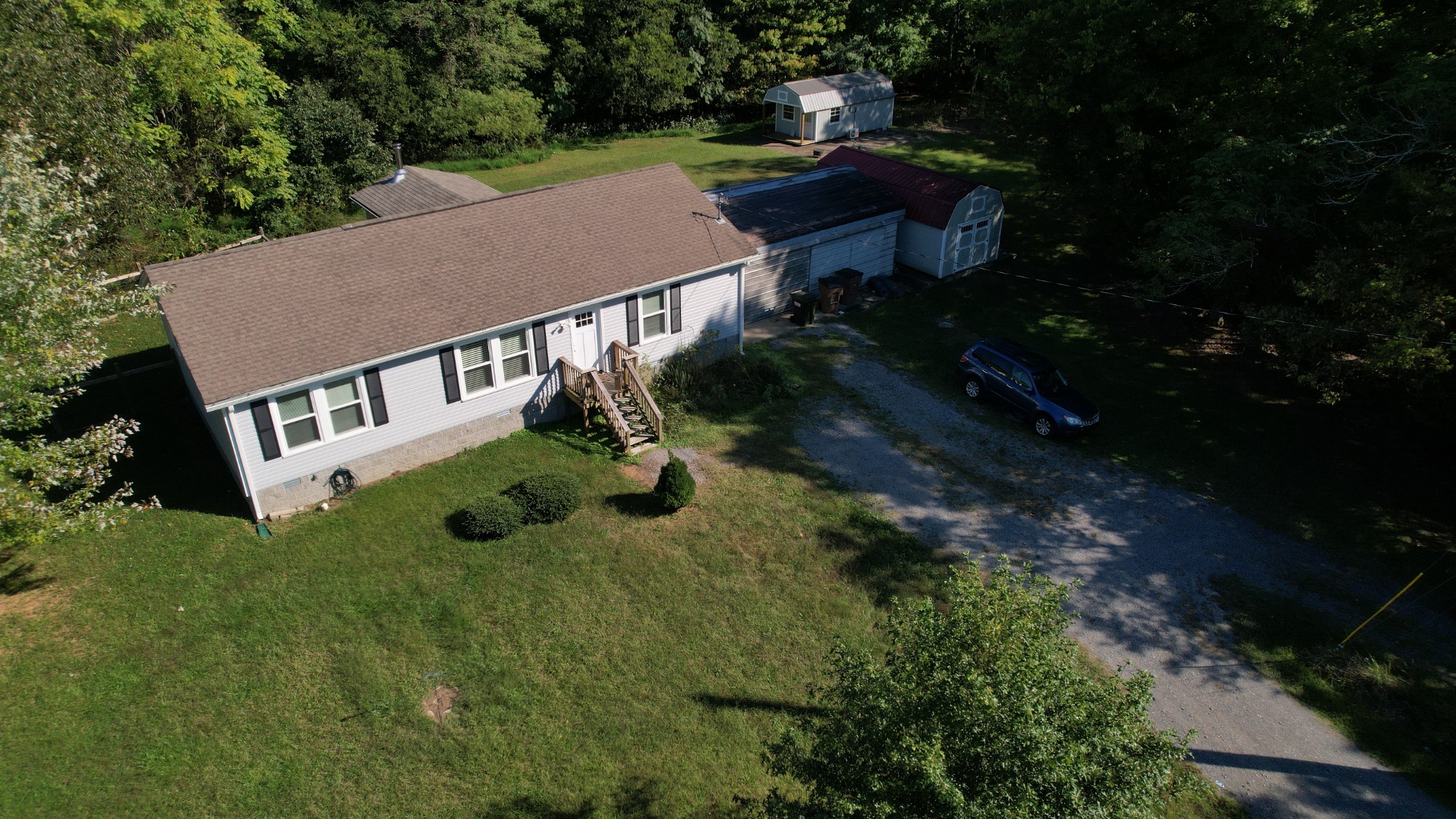 an aerial view of a house with a yard table and chairs