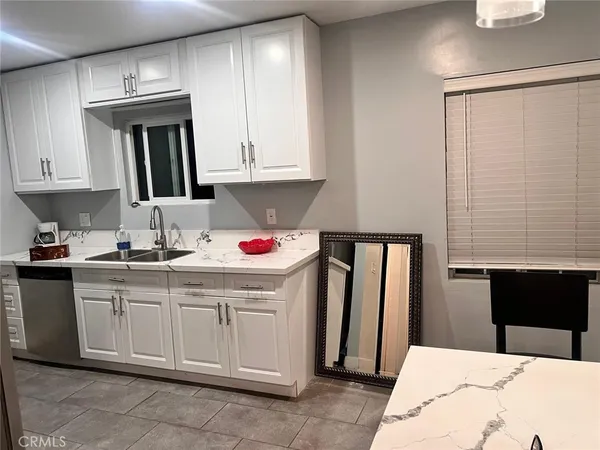 a kitchen with a sink cabinets and appliances