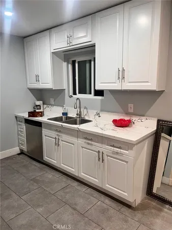 a kitchen that has a sink and cabinets in it