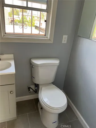 a bathroom with a toilet a sink and a window