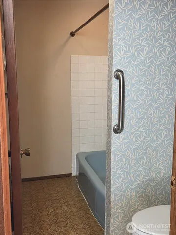 a bathroom with a shower and toilet