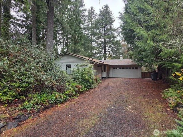 a view of a house with large trees