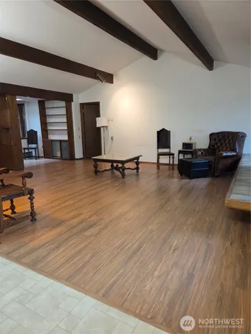 a view of living room with furniture and wooden floor