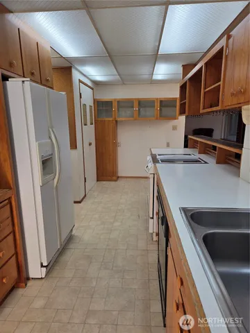 a kitchen with a refrigerator and a sink