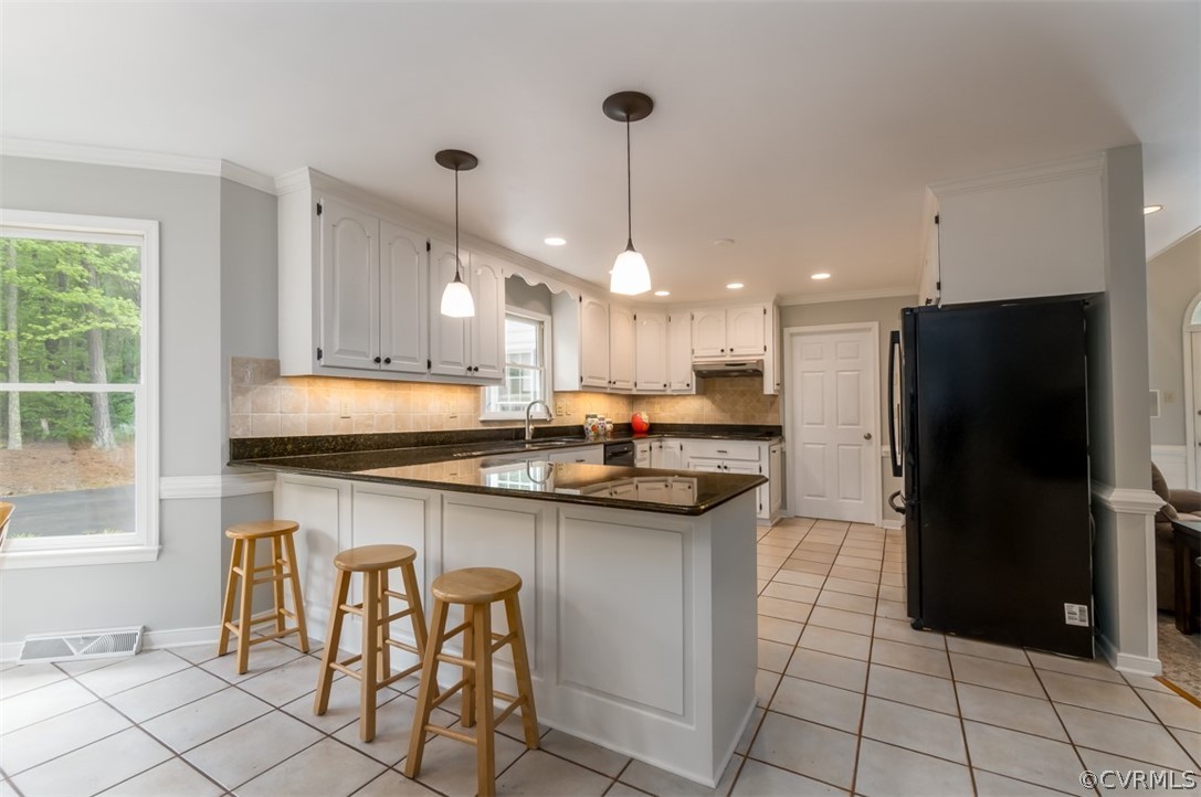 9820 Taylor Road Chesterfield, VA 23838 - Photo 15 of 40 a kitchen with stainless steel appliances granite countertop a sink a stove a refrigerator and island with wooden floor