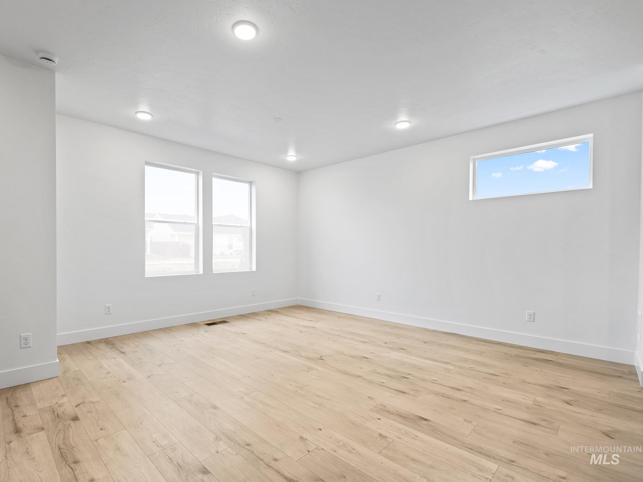 6369 South Sachet Avenue Meridian, ID 83642 - Photo 5 of 13 Spare room featuring light wood finished floors and baseboards