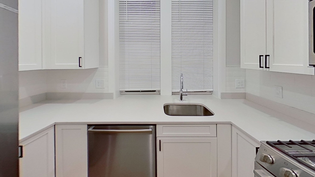47 Englewood Avenue, Unit 5 Boston, MA 02135 - Photo 1 of 7 a kitchen with a sink and a stove