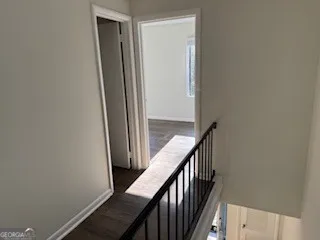 a view of a hallway with wooden floor