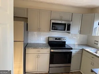 a kitchen with a stove and a microwave