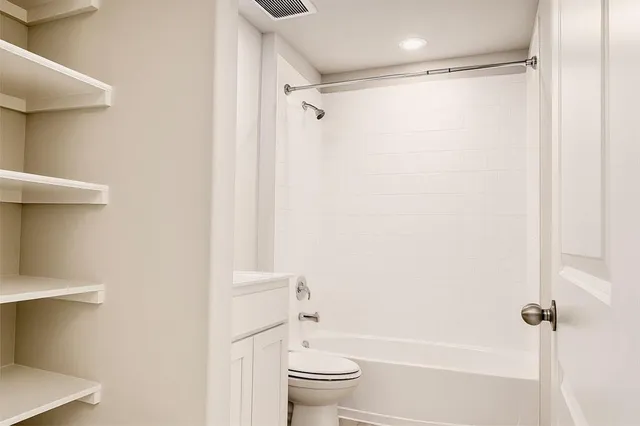 a bathroom with a shower a toilet and a shower