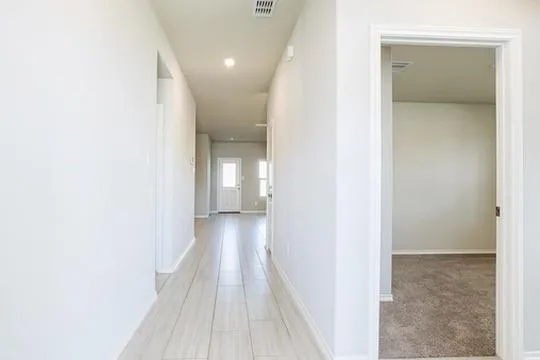 a view of a room with wooden floor