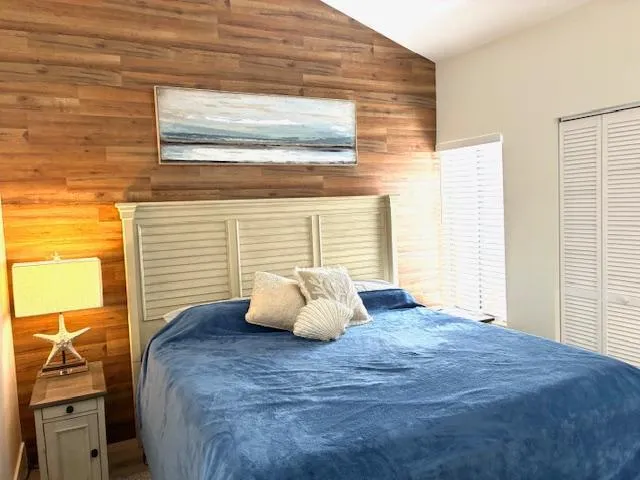 a large bed sitting in a bedroom next to a window