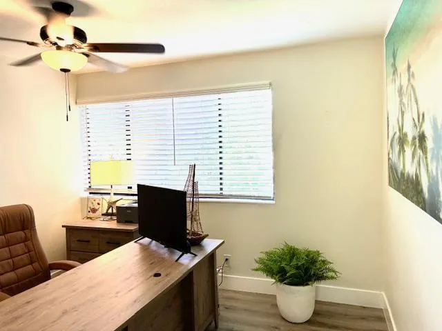 a view of a workspace with furniture and a potted plant