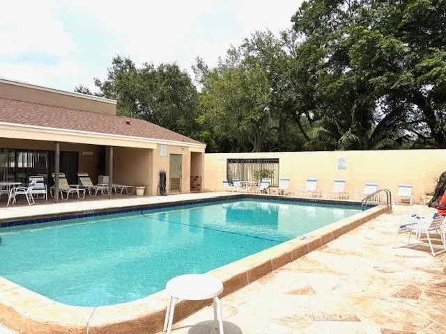 a view of a house with swimming pool and sitting area