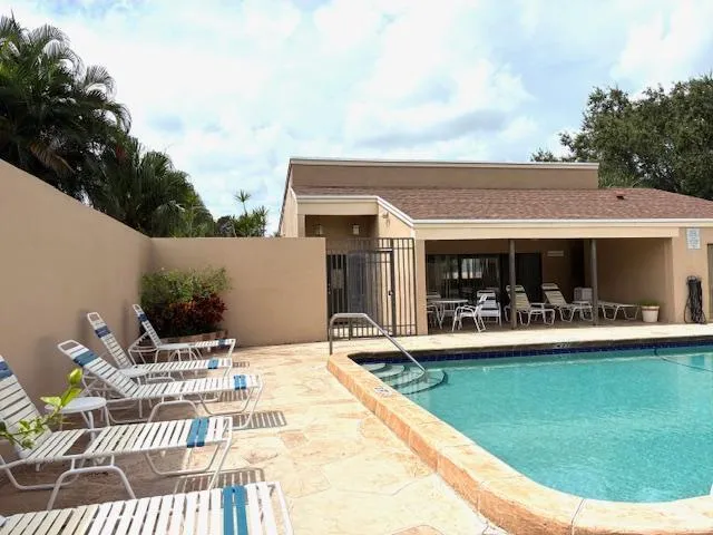a view of a patio with table and chairs with wooden floor and fence