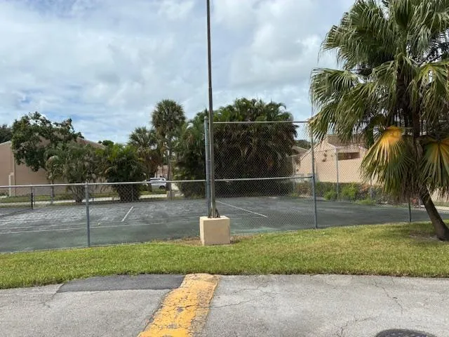 a front view of a house with a garden and plants