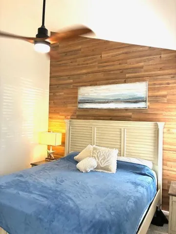 a view of a room with a bed and a window