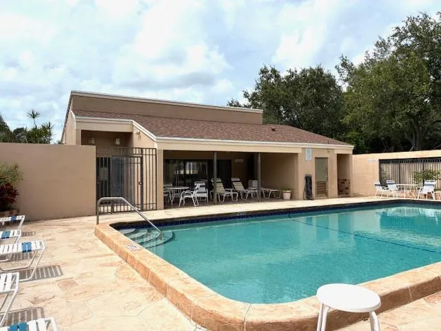 a view of a house with swimming pool and sitting area