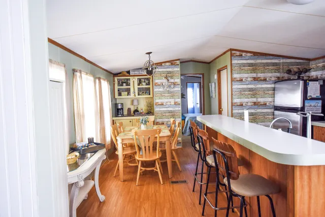 a dining room with furniture and a window