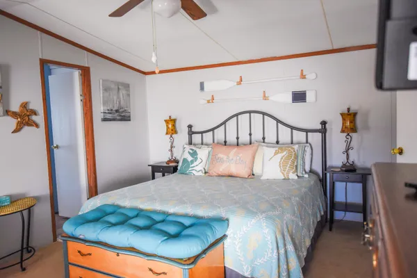 a bedroom with a large bed and a chandelier