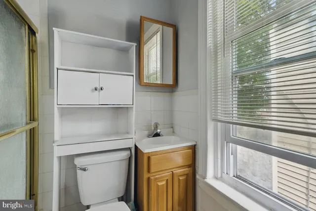a bathroom with a toilet sink and mirror