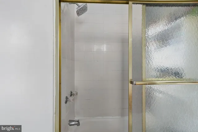 a bathroom with a glass shower door