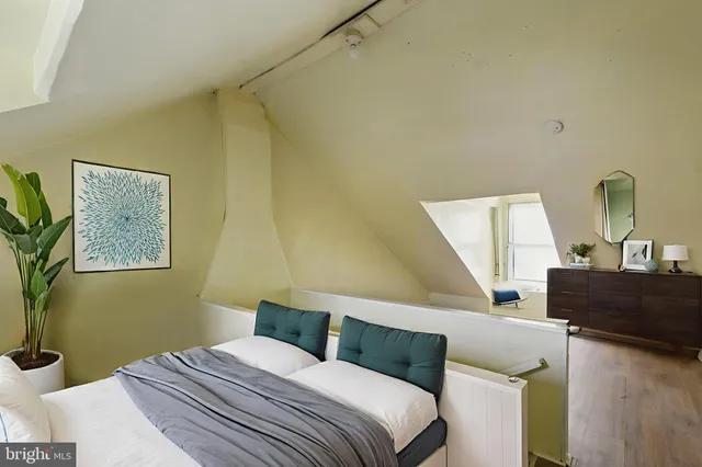 a bedroom with a bed and a dresser