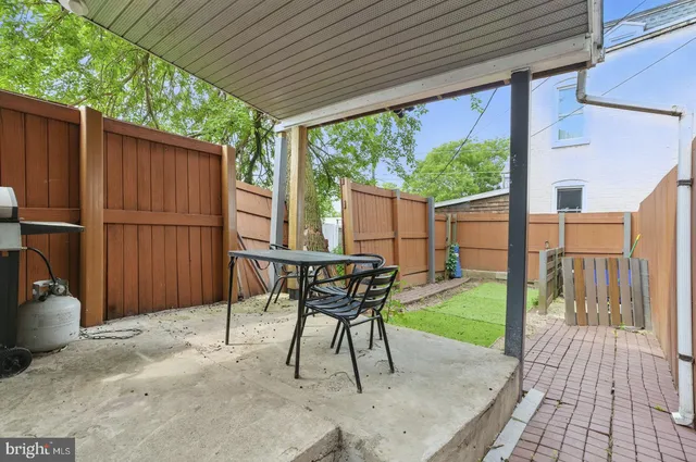 a patio with table and chairs