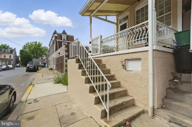 a view of a white building with a ceiling fan