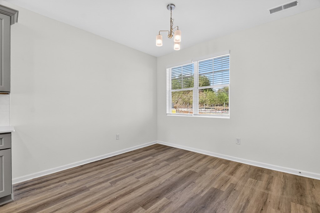 7 Grove Loop Blue Ridge, GA 30513 - Photo 19 of 33 wooden floor in an empty room with a window
