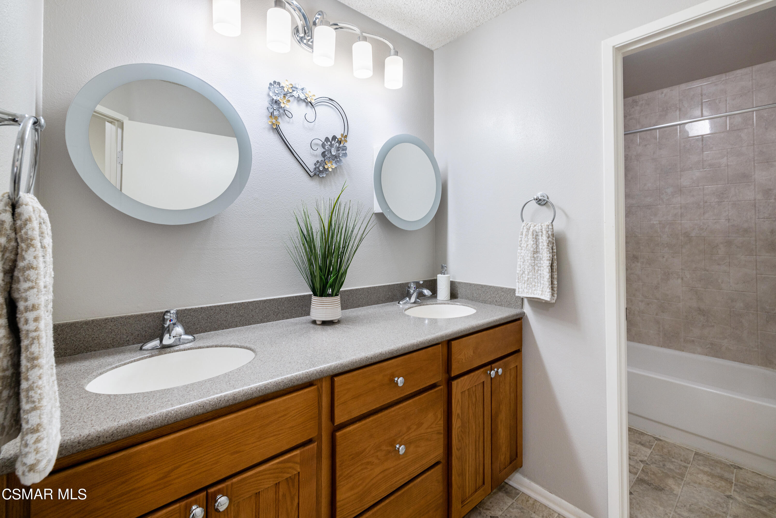 3330 Darby Street, Unit 409 Simi Valley, CA 93063 - Photo 17 of 27 a bathroom with a granite countertop double vanity and a mirror