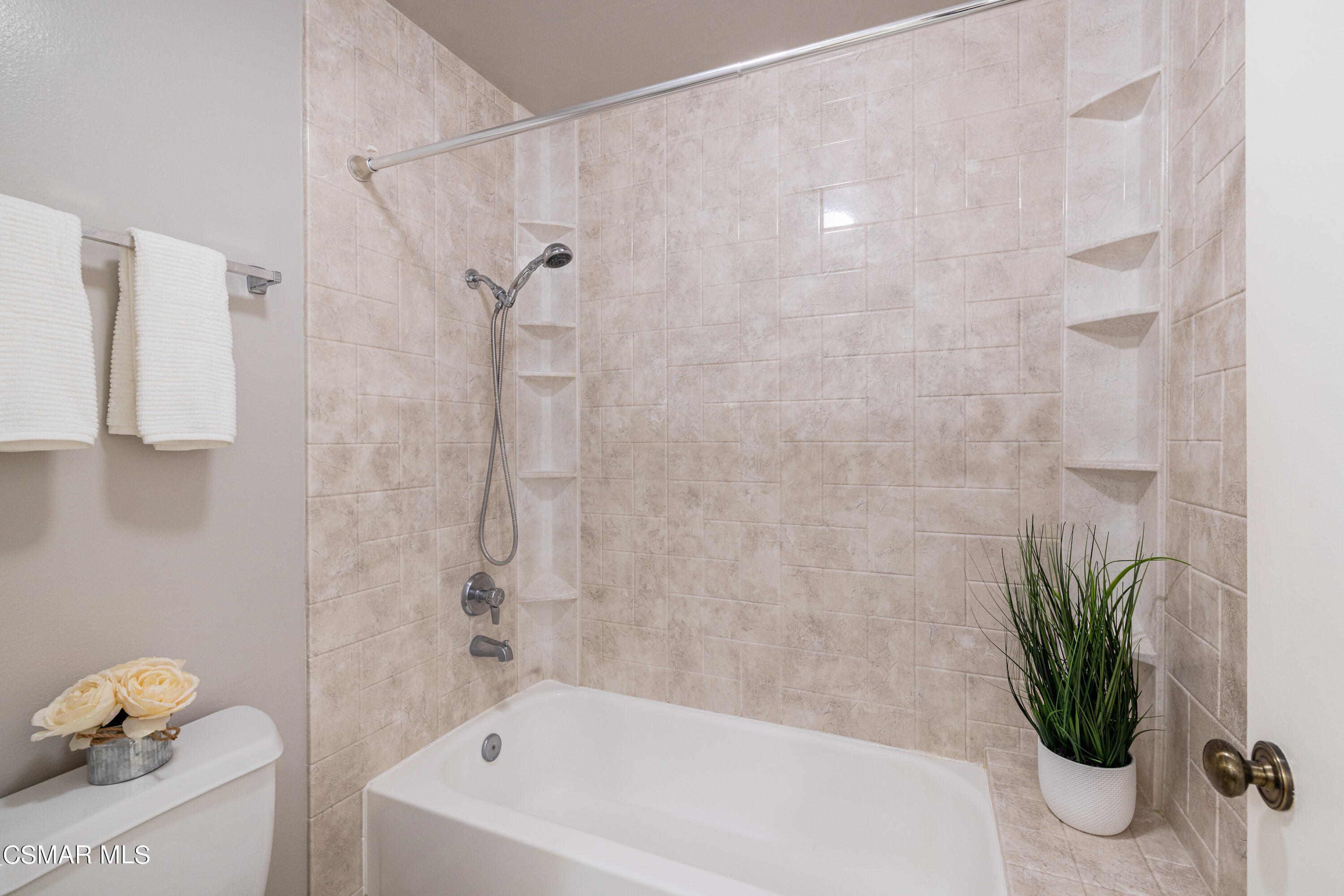 3330 Darby Street, Unit 409 Simi Valley, CA 93063 - Photo 18 of 27 a bathroom with a shower curtain a sink and a bathtub