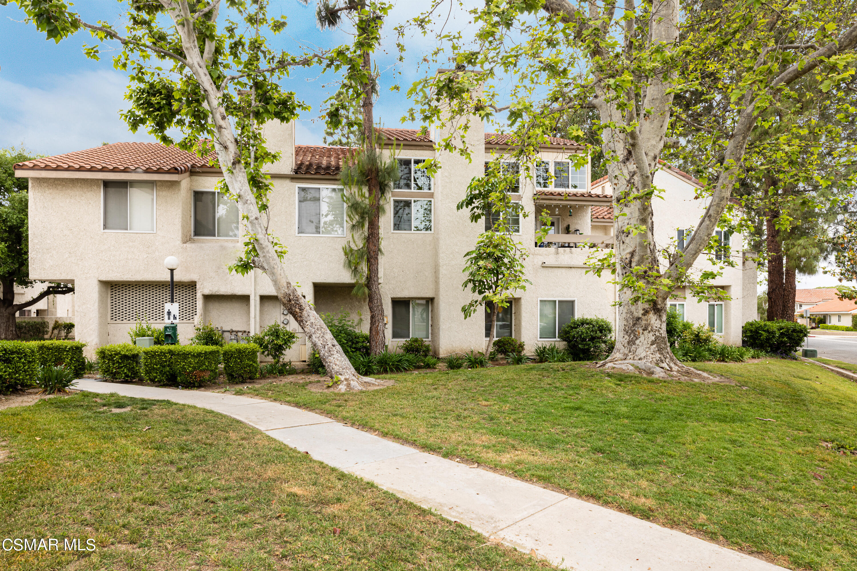 3330 Darby Street, Unit 409 Simi Valley, CA 93063 - Photo 2 of 27 a front view of a house with a yard