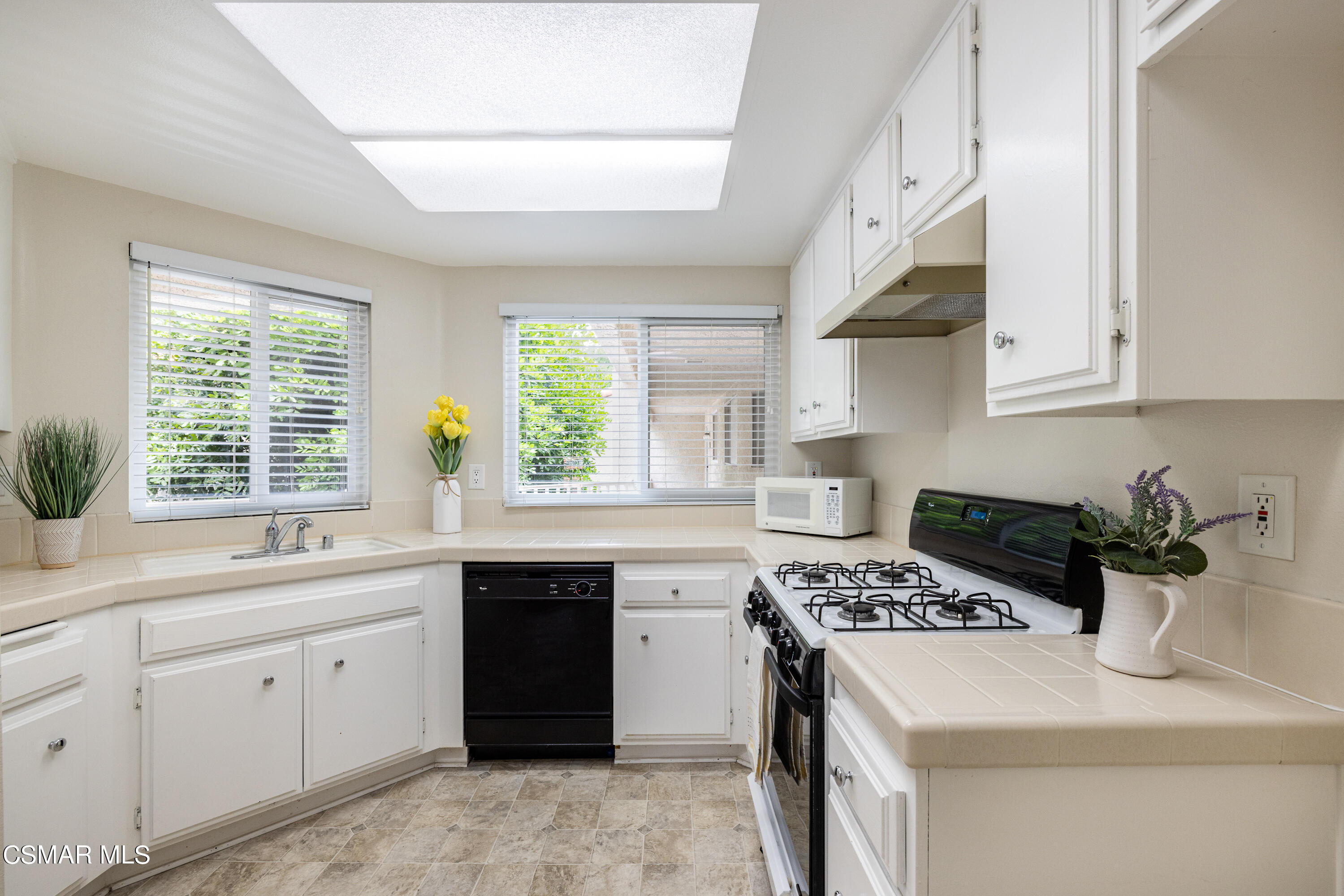 3330 Darby Street, Unit 409 Simi Valley, CA 93063 - Photo 9 of 27 a kitchen with a sink stove and window