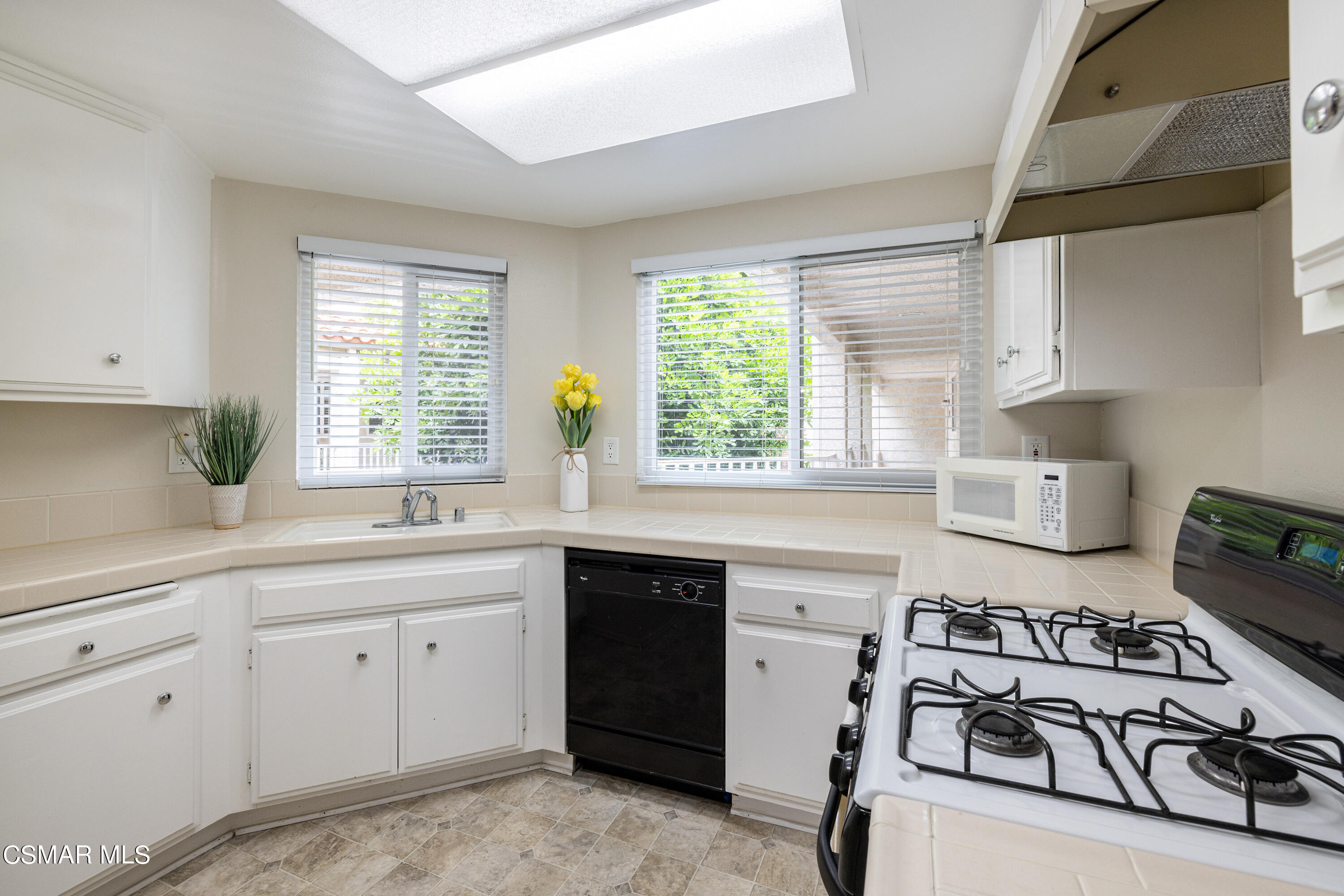 3330 Darby Street, Unit 409 Simi Valley, CA 93063 - Photo 10 of 27 a kitchen with a sink stove and cabinets