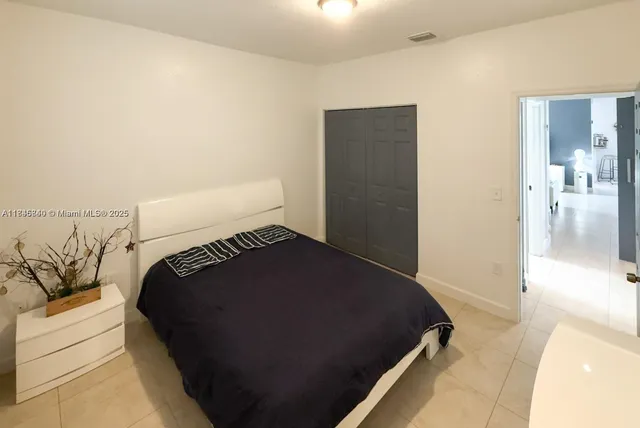 a bedroom with a bed and a night stand