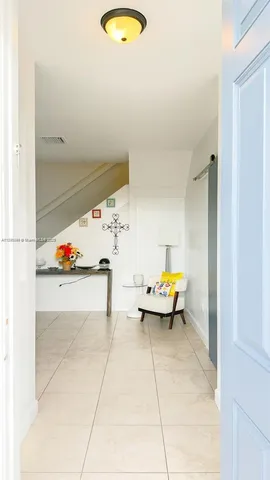 a view of living room with furniture and white walls