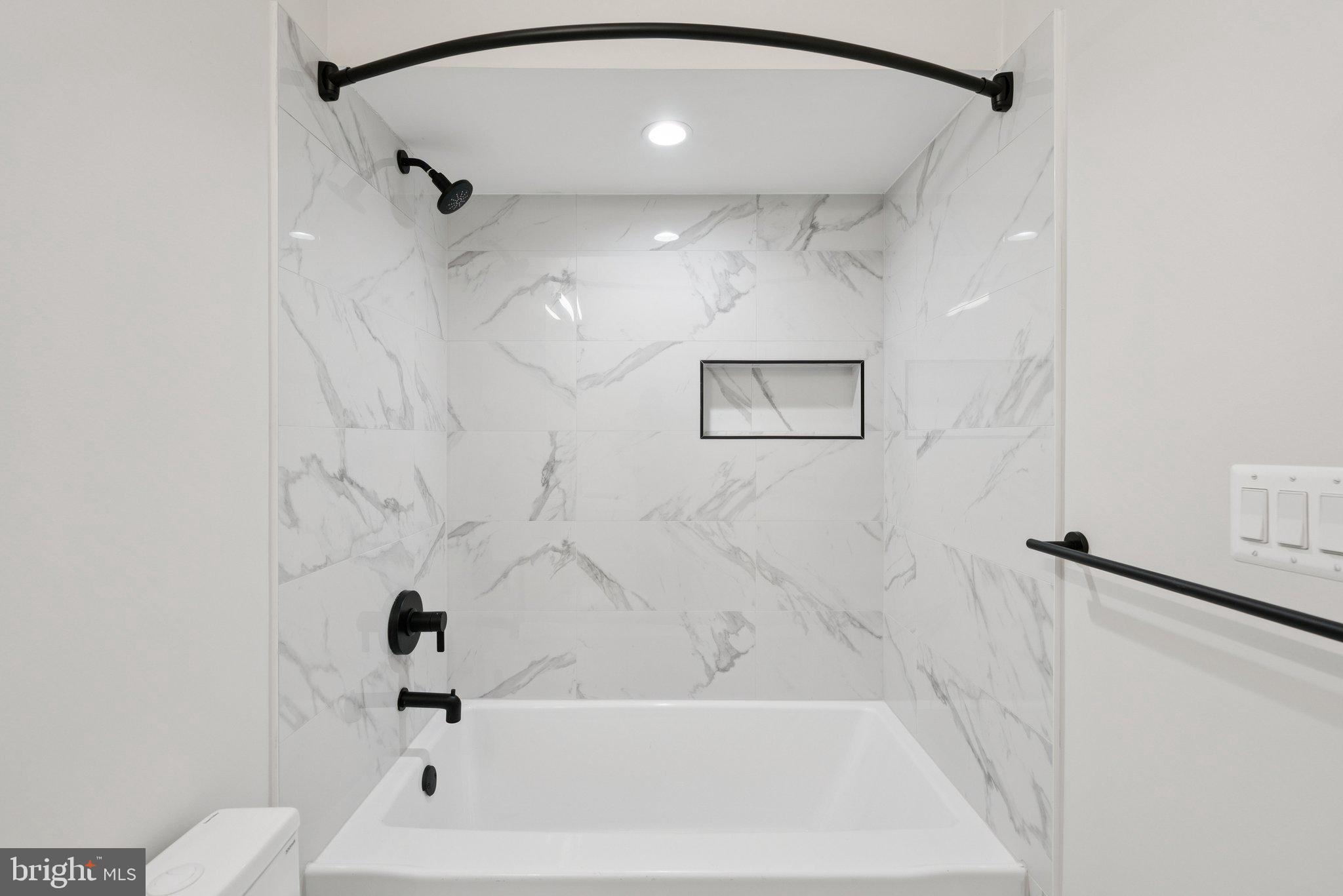 2134 Wisconsin Avenue Northwest, Unit 3 Washington, DC 20007 - Photo 20 of 40 a bathroom with a bathtub and shower