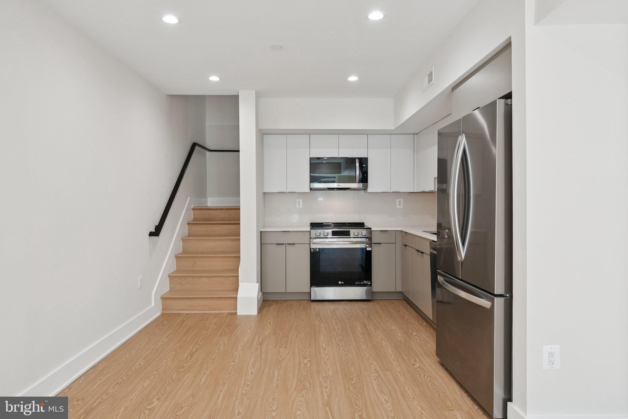 2134 Wisconsin Avenue Northwest, Unit 3 Washington, DC 20007 - Photo 2 of 40 a kitchen with a refrigerator a sink and a stove