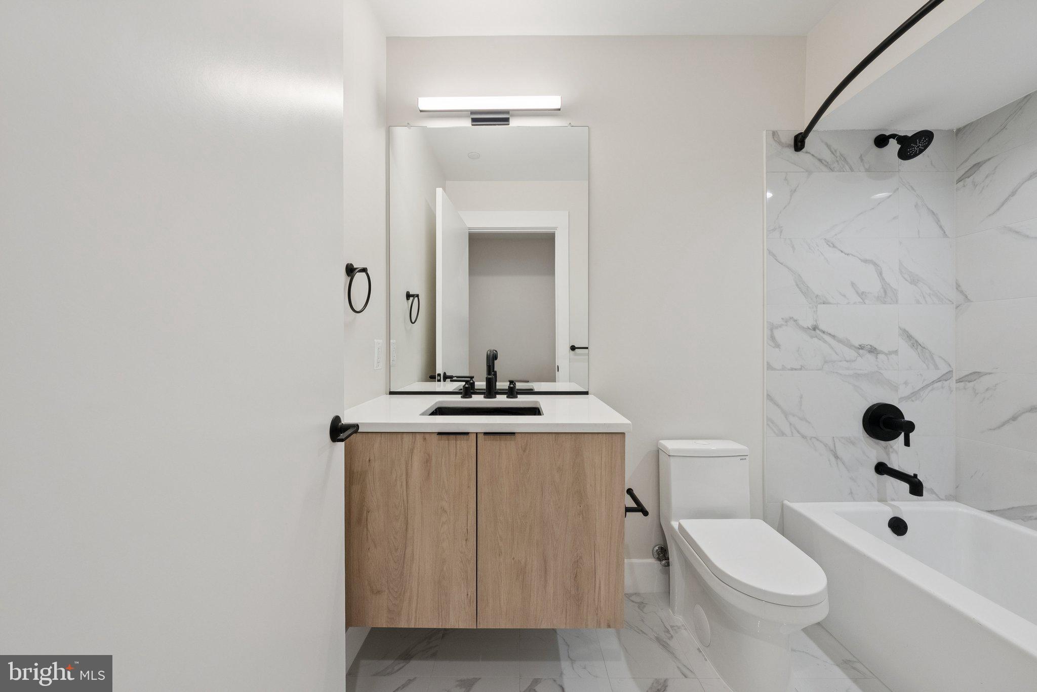 2134 Wisconsin Avenue Northwest, Unit 3 Washington, DC 20007 - Photo 21 of 40 a bathroom with a sink a toilet and shower