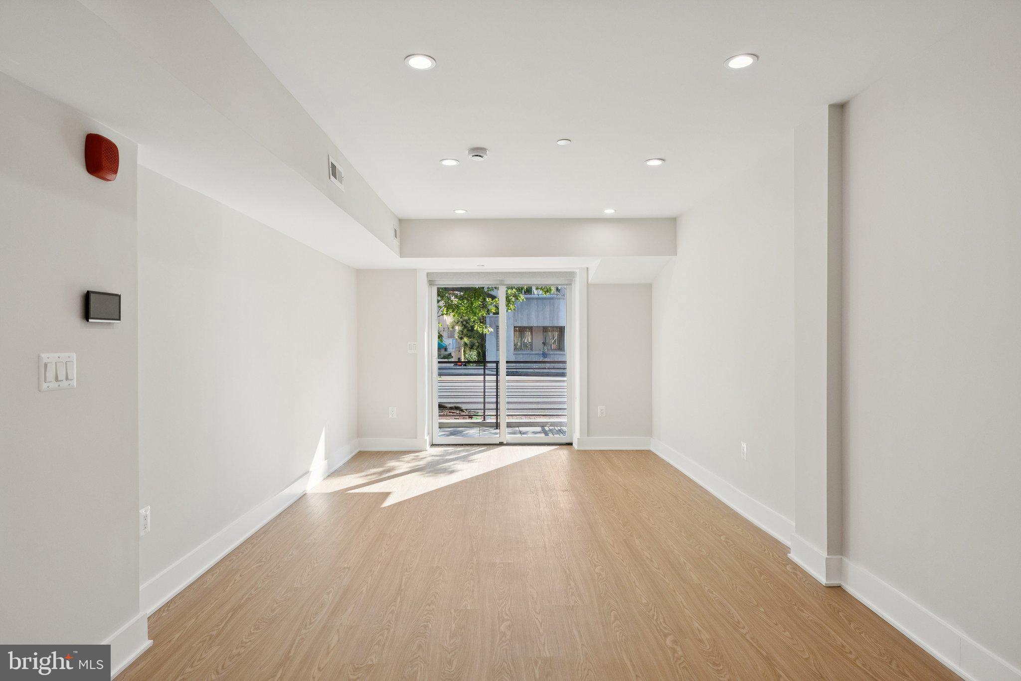 2134 Wisconsin Avenue Northwest, Unit 3 Washington, DC 20007 - Photo 5 of 40 a view of an empty room with a window