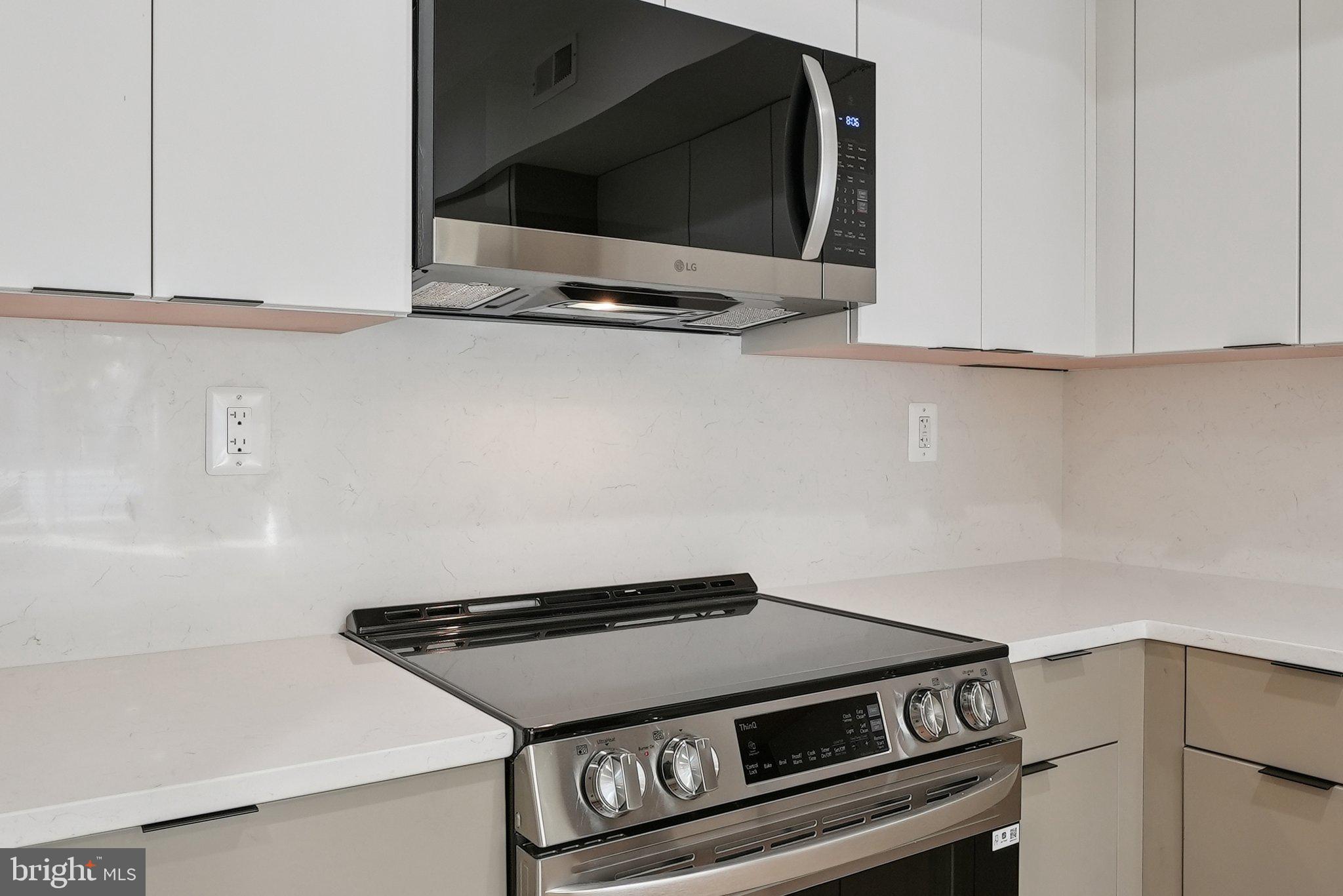 2134 Wisconsin Avenue Northwest, Unit 3 Washington, DC 20007 - Photo 8 of 40 a stove top oven sitting inside of a kitchen