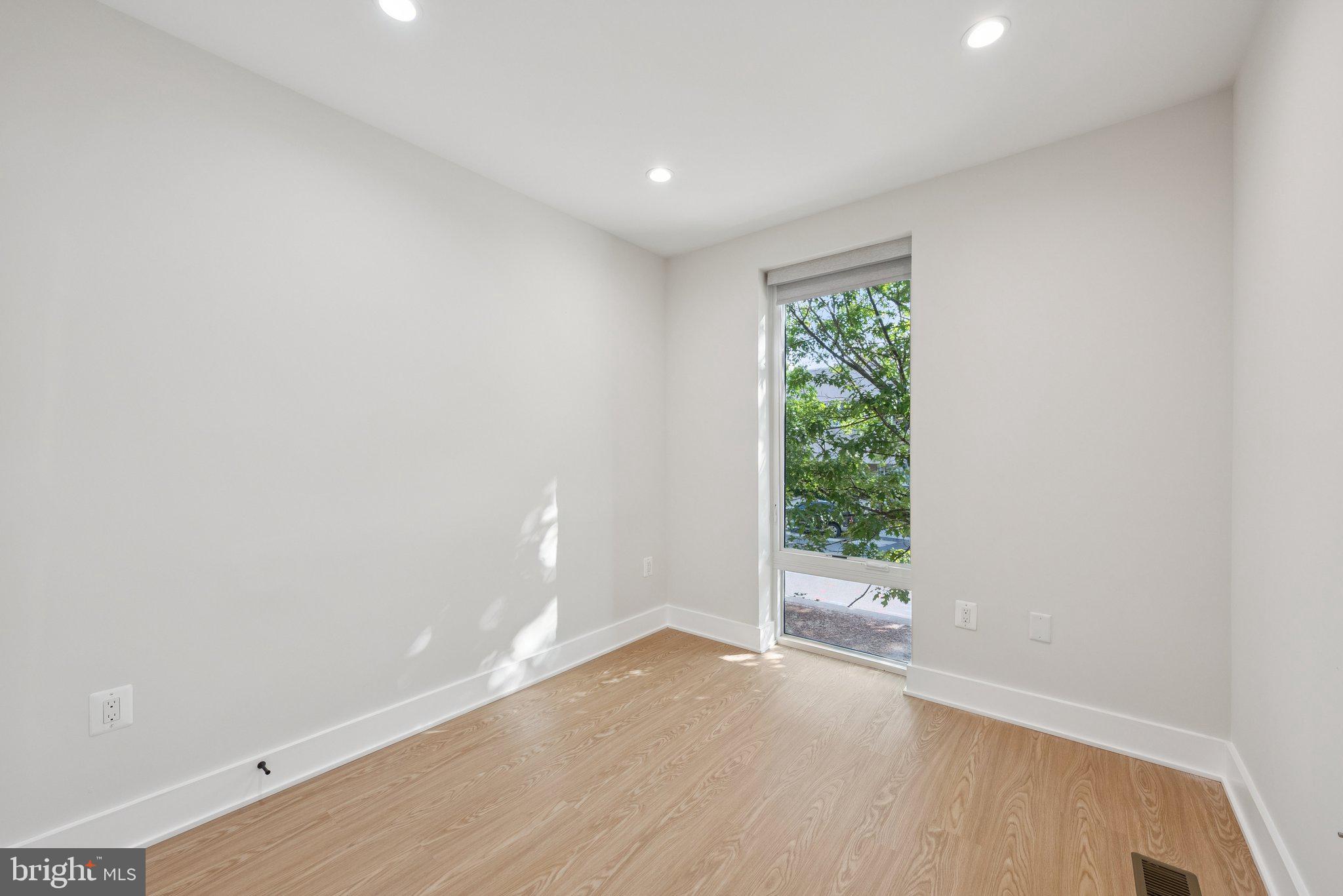2134 Wisconsin Avenue Northwest, Unit 3 Washington, DC 20007 - Photo 10 of 40 an empty room with wooden floor and windows