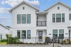 a view of a white house with large windows