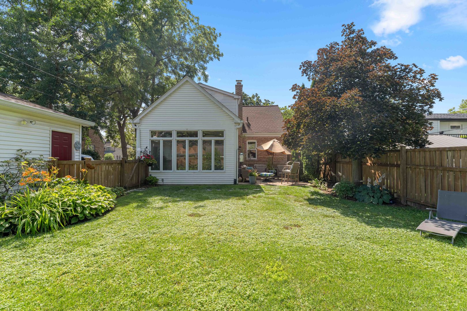 725 North County Line Road Hinsdale, IL 60521 - Photo 25 of 34 a backyard of a house with wooden fence and trees