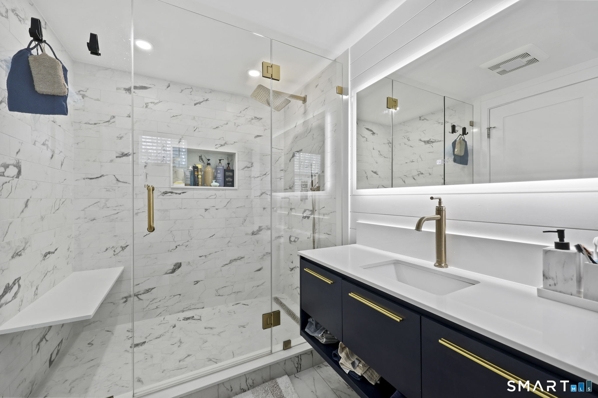 36 North Street Trumbull, CT 06611 - Photo 12 of 23 a bathroom with a shower sink and mirror