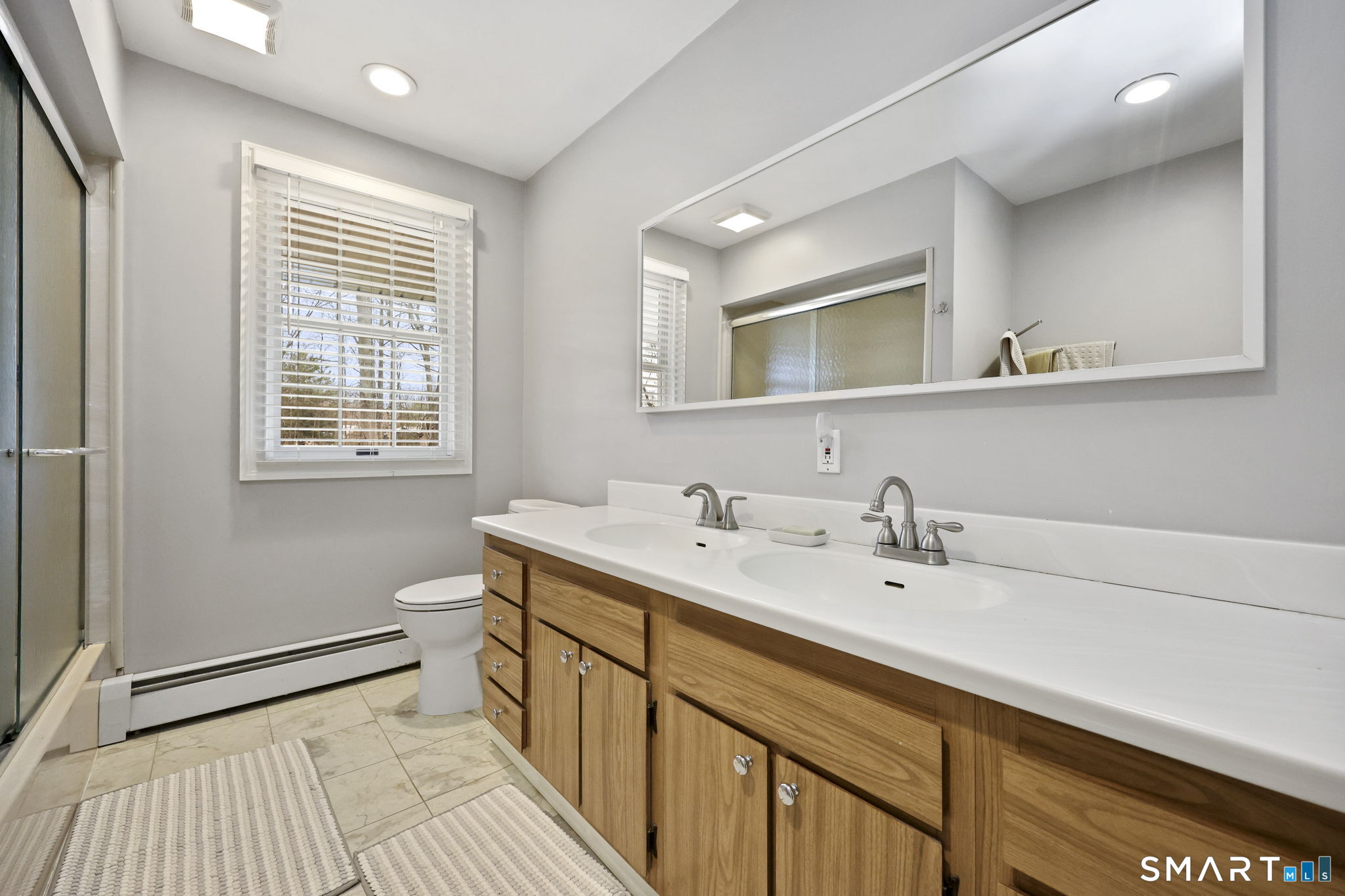 36 North Street Trumbull, CT 06611 - Photo 16 of 23 a bathroom with a sink a mirror and a window