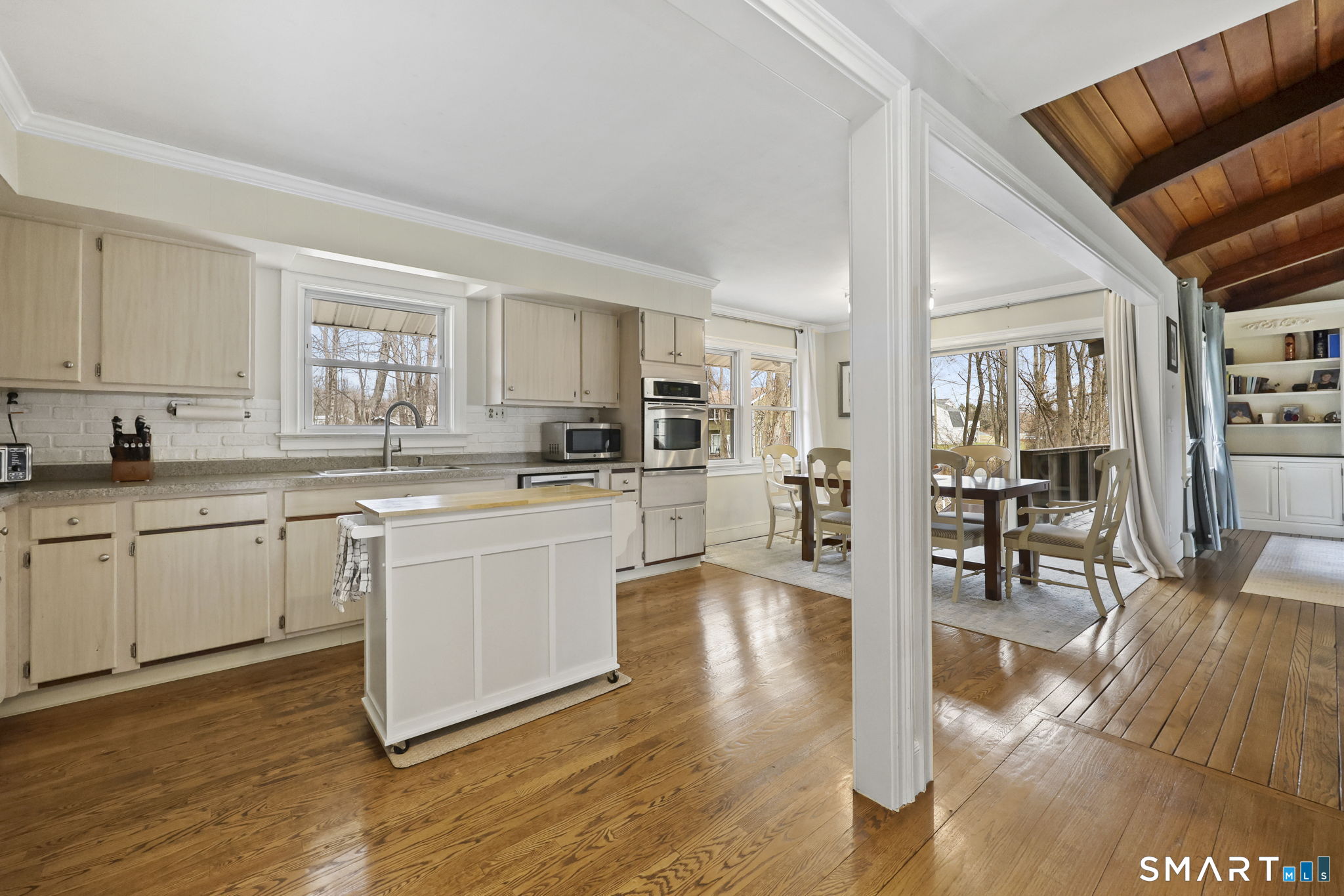 36 North Street Trumbull, CT 06611 - Photo 4 of 23 a kitchen with wooden floors and white cabinets