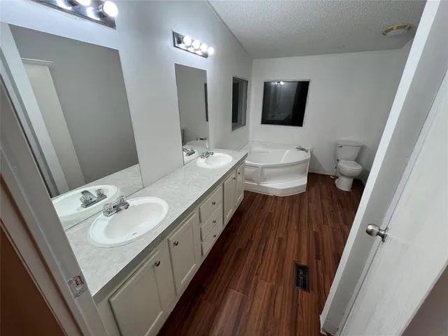 a bathroom with a double vanity sink and mirror