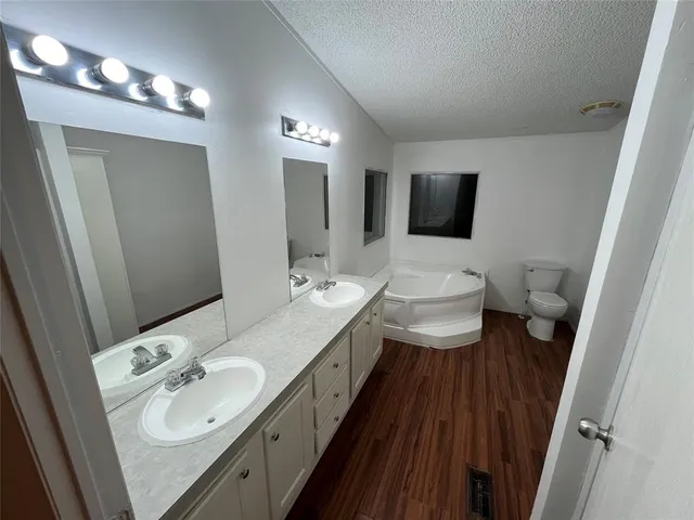 a bathroom with a double vanity sink and a mirror